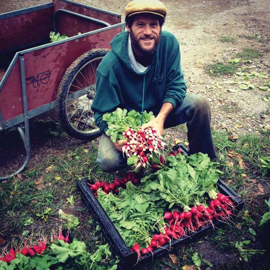 Husband and head farmer Eric shows off his beautiful radishes.